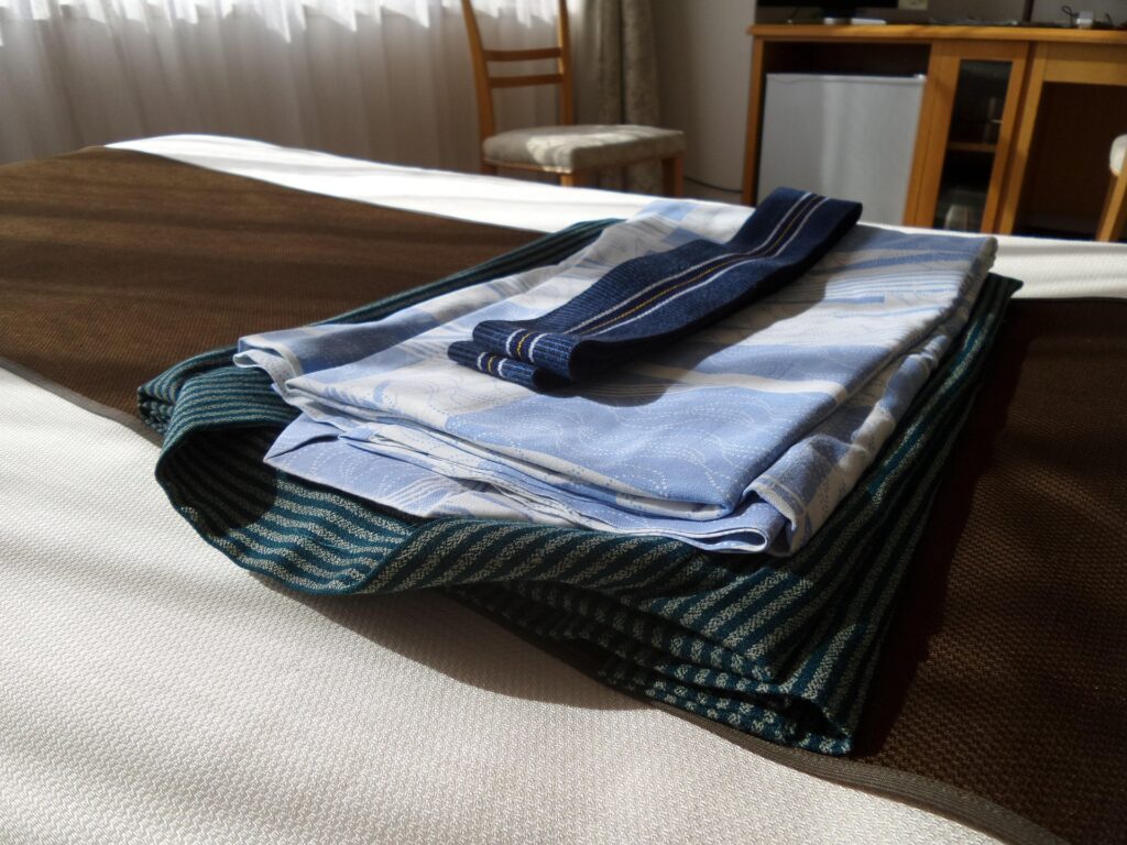 Folded yukata and obi prepared for a summer festival in Japan.