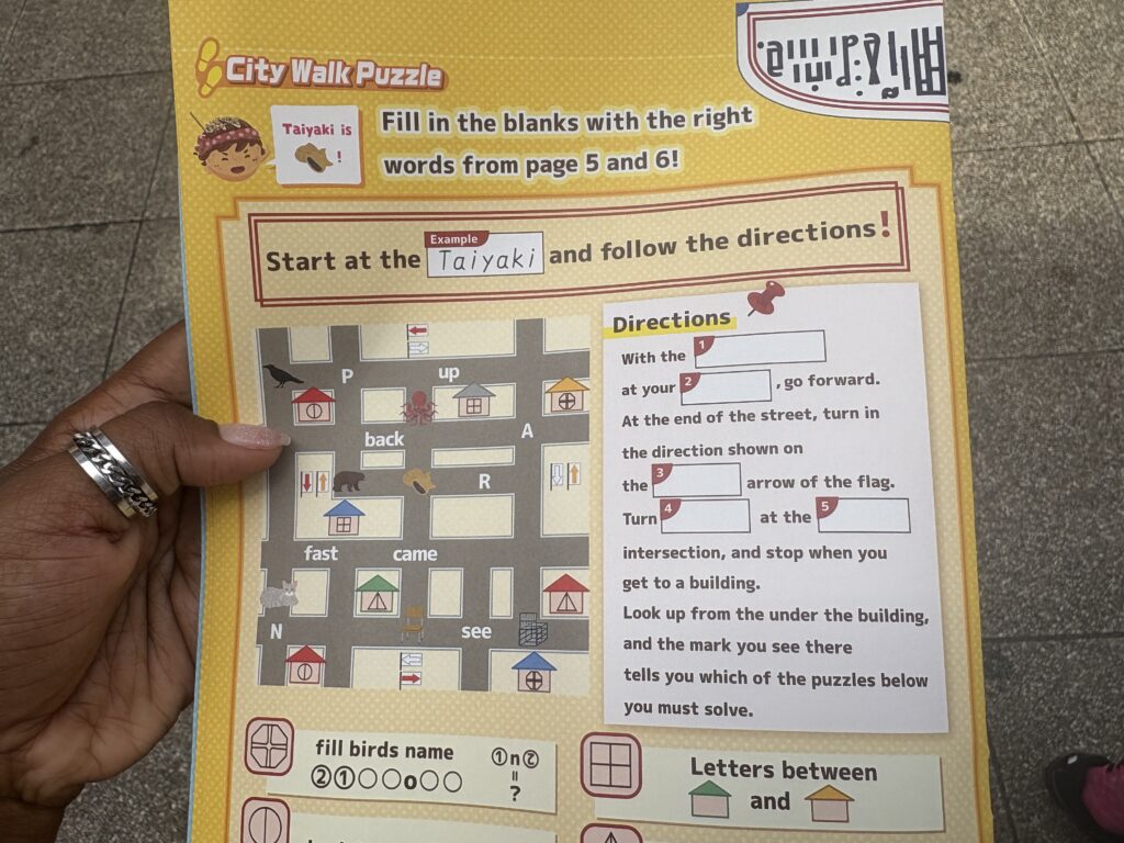 A Playful Osaka Mystery Walk booklet filled with colorful illustrations of famous Osaka sights and foods.