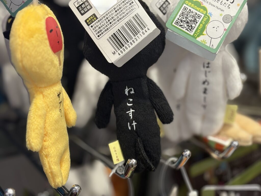 Quirky Japanese character plushies displayed inside a shop discovered along the mystery walk route.