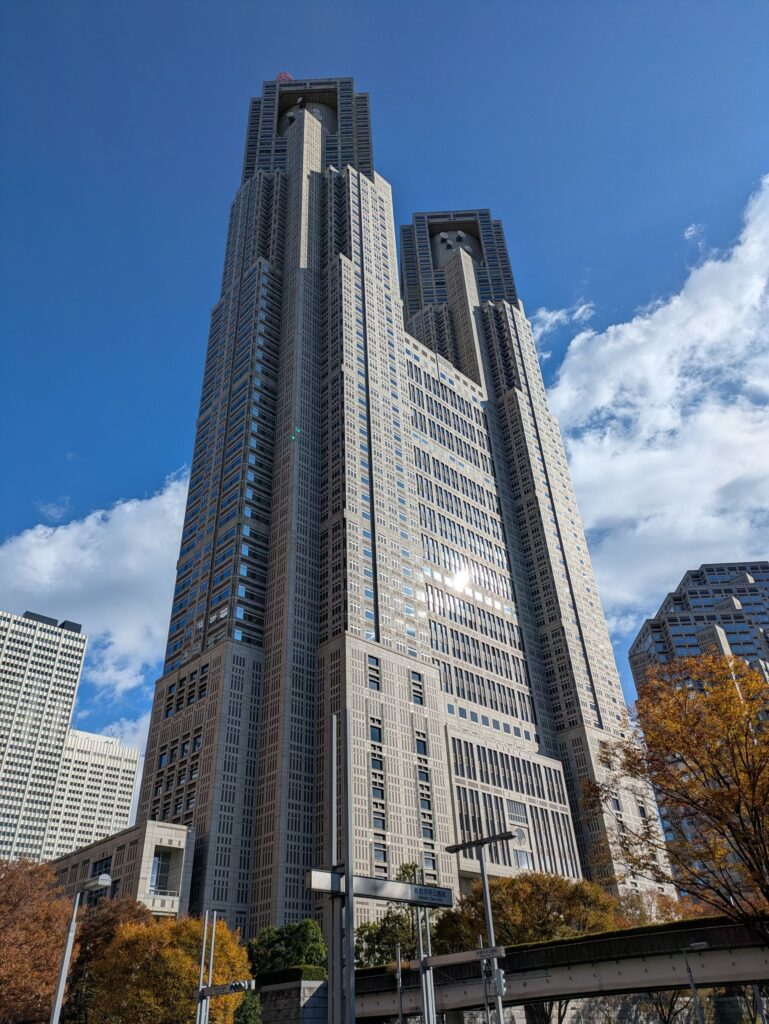Tokyo Metropolitan Government Building in Shinjuku, Tokyo, rising against a bright blue sky.