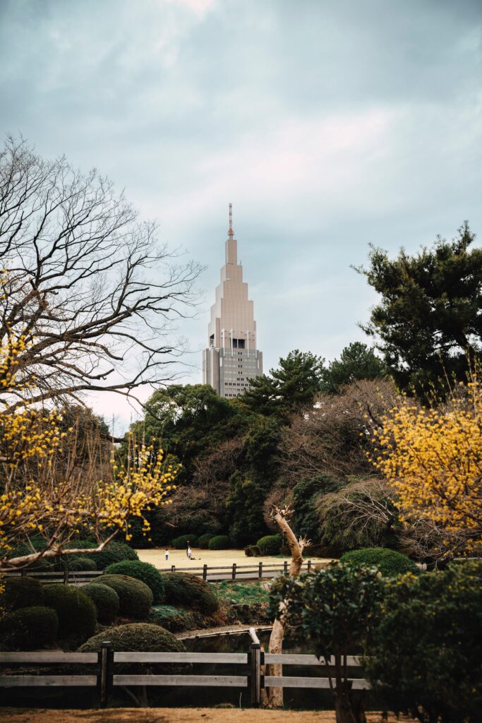 NTT Docomo Yoyogi Building rising above trees and gardens near Shinjuku, Tokyo.