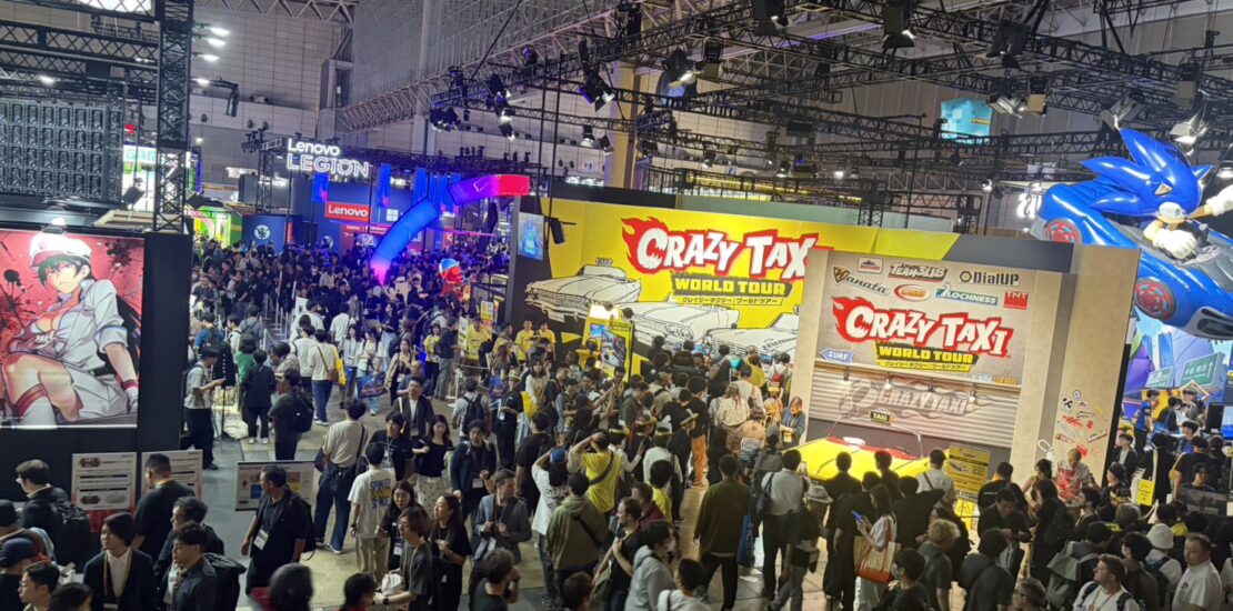 Crowded Tokyo Game Show 2026 exhibition floor featuring the Crazy Taxi World Tour booth at Makuhari Messe.