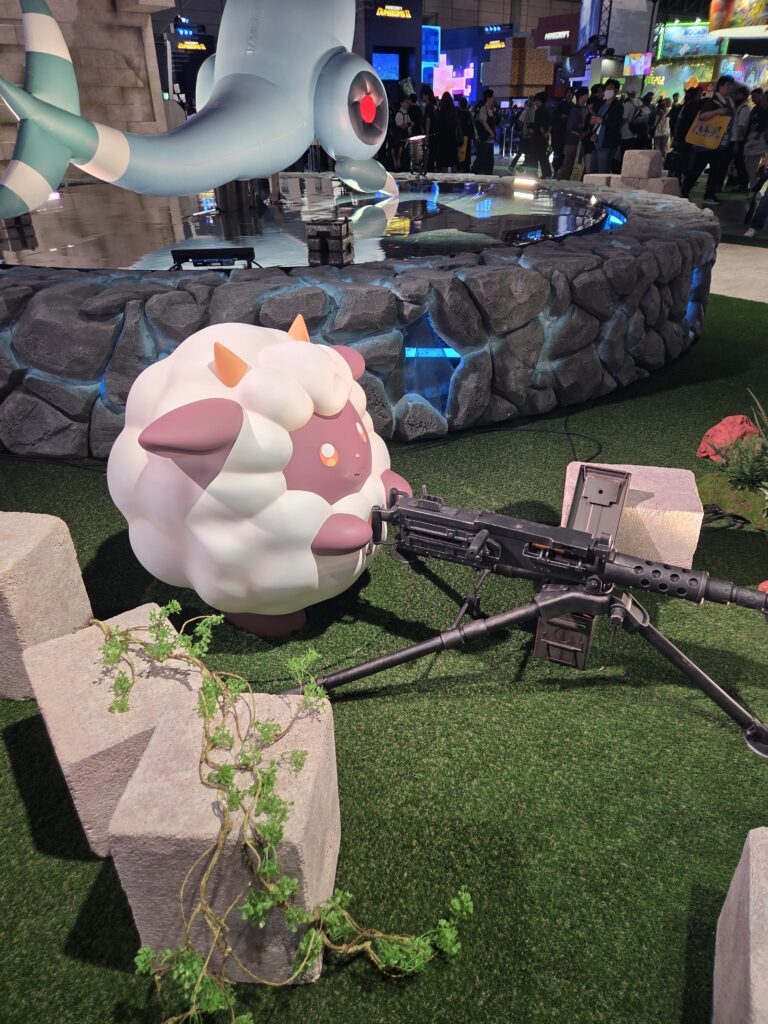 Pocketpair's official merchandise booth at Tokyo Game Show 2026 featuring Palworld trading cards, booster boxes, plush toys, and clothing.