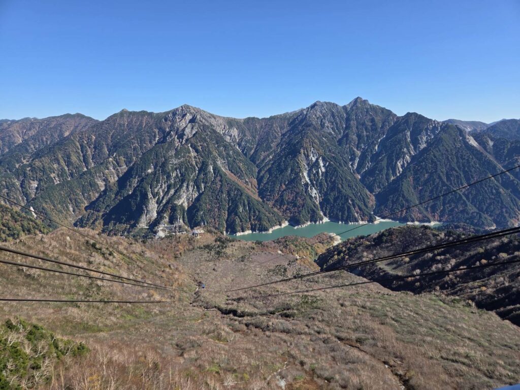 Stunning Mikurigaike Pond at Murodo, surrounded by rugged mountain peaks and beautiful autumn scenery in the Northern Japan Alps.