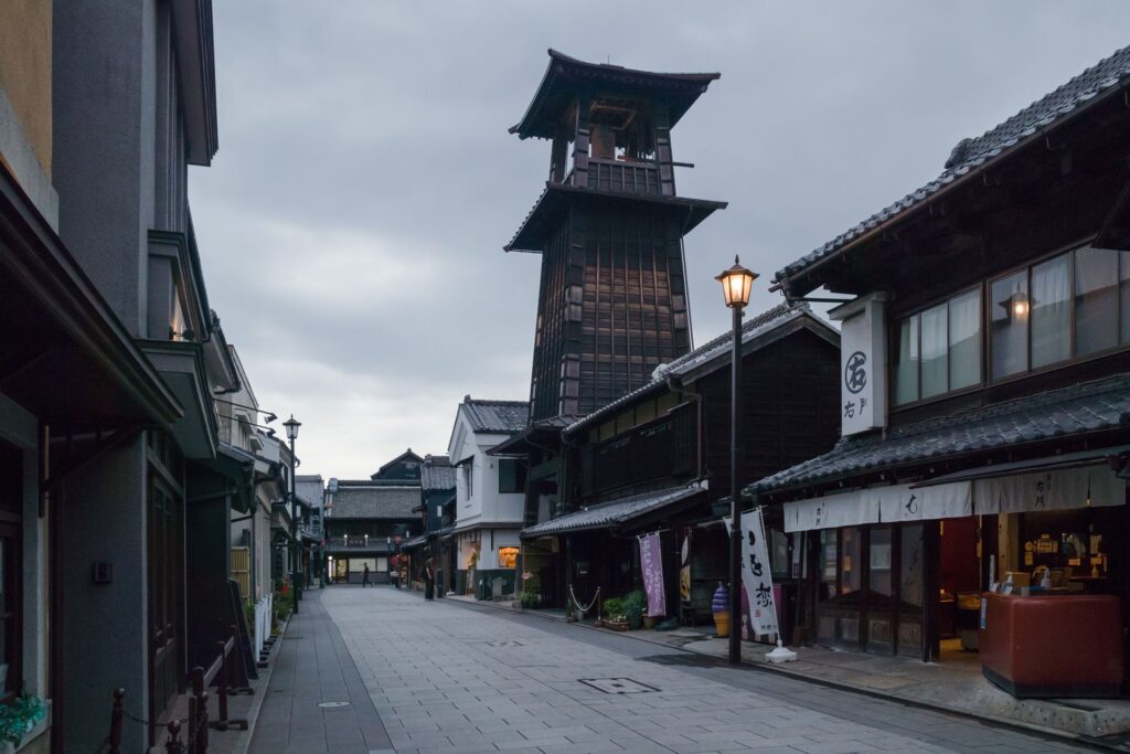 Historic streets of Kawagoe in Saitama, Japan, featuring traditional Japanese wooden buildings and the iconic Toki no Kane bell tower.