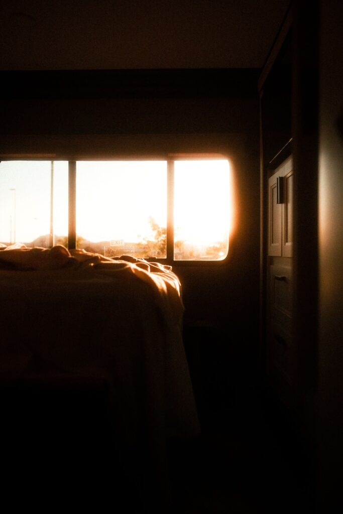 Warm sunlight streams through a large bedroom window, highlighting the importance of window insulation for keeping Japanese apartments comfortable during winter.